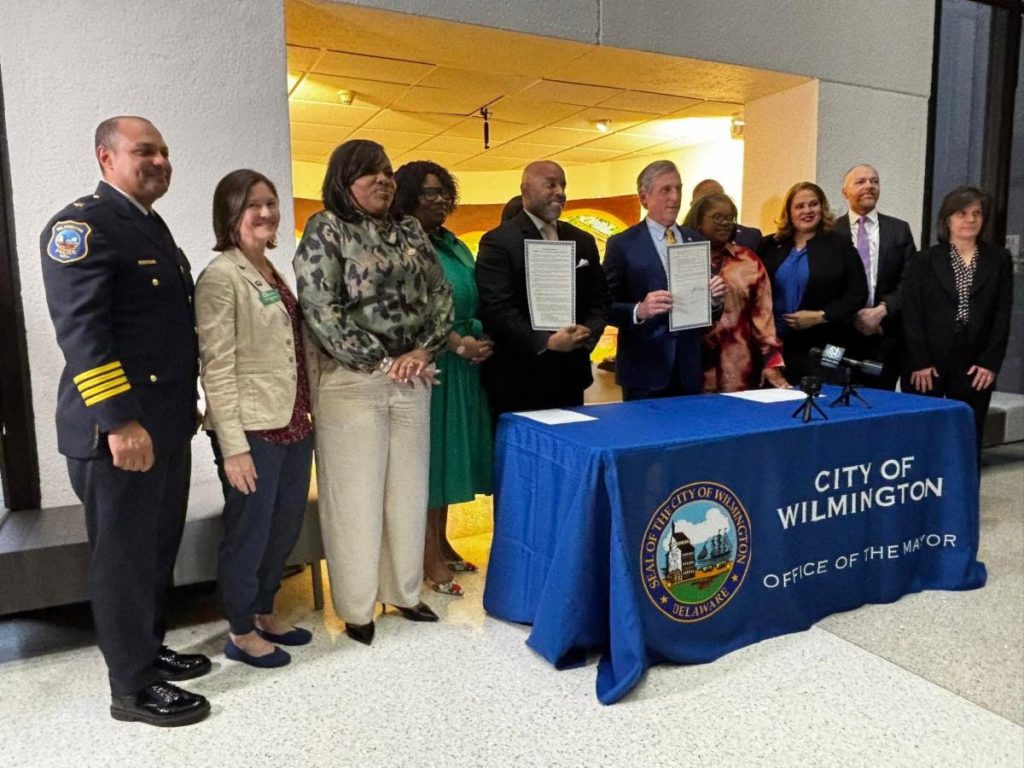 Group of Wilmington officials posing behind a table